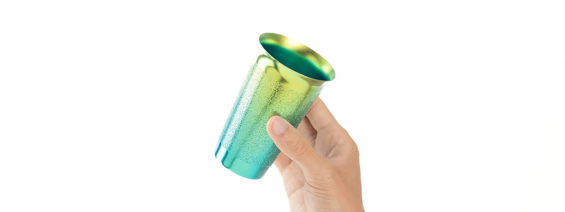 HORIE Beer Cup titanium tumbler in hand, Japanese handcrafted drinkware, gradient rainbow finish – Made in Japan.