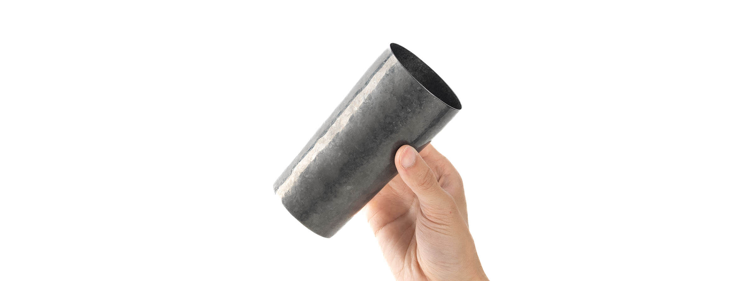 HORIE Saiko Series titanium tumbler in charcoal finish, double-walled Japanese artisanal drinkware held in hand.