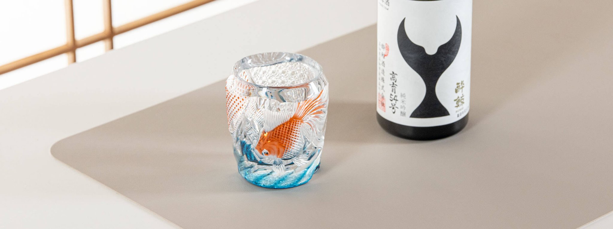 Edo Kiriko Rock Glass with orange goldfish motif, handcrafted by master Tadano Hidero, displayed as a banner on the product category page for rock glasses.