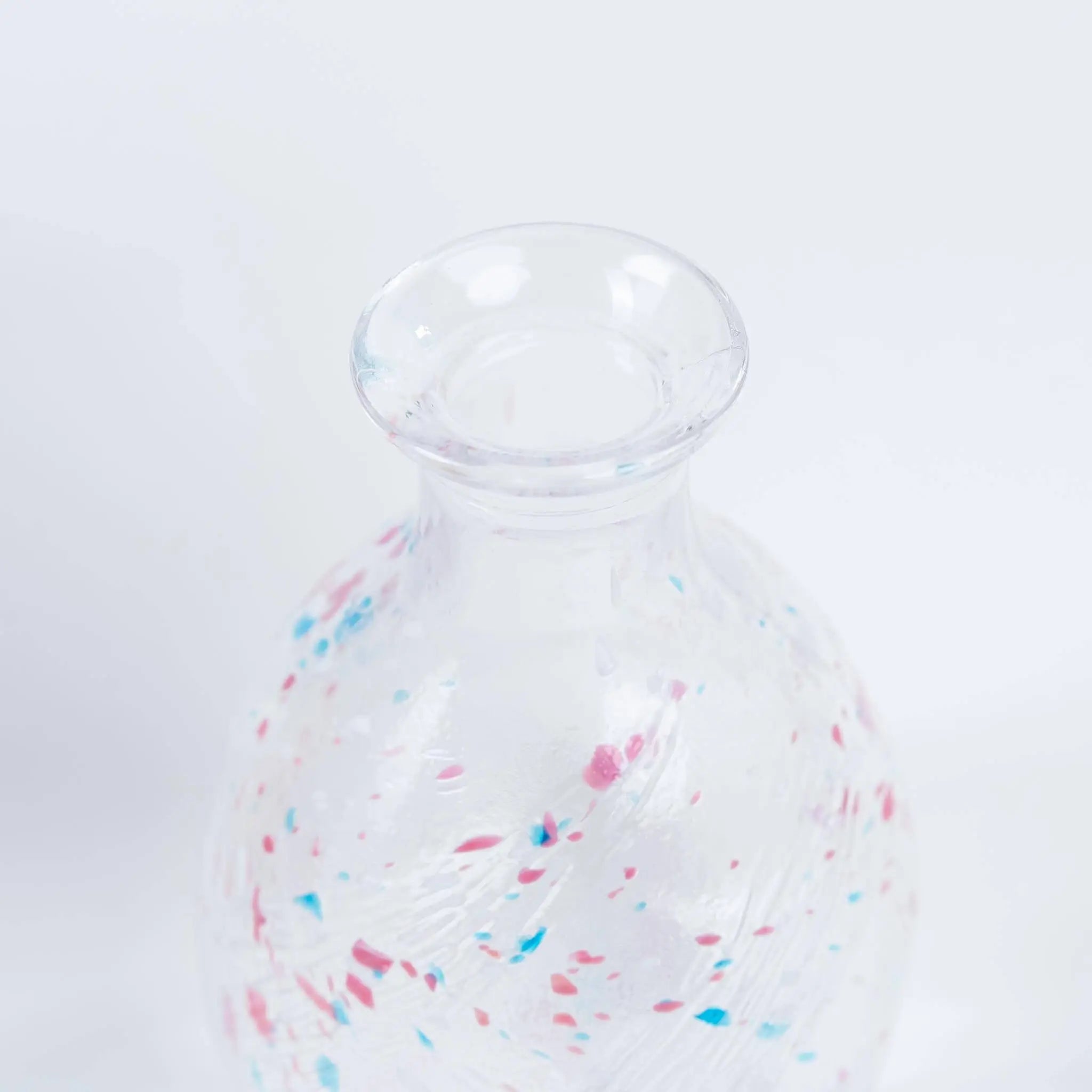 Detail of handmade Japanese sake bottle showing delicate glass craftsmanship and smooth pouring design