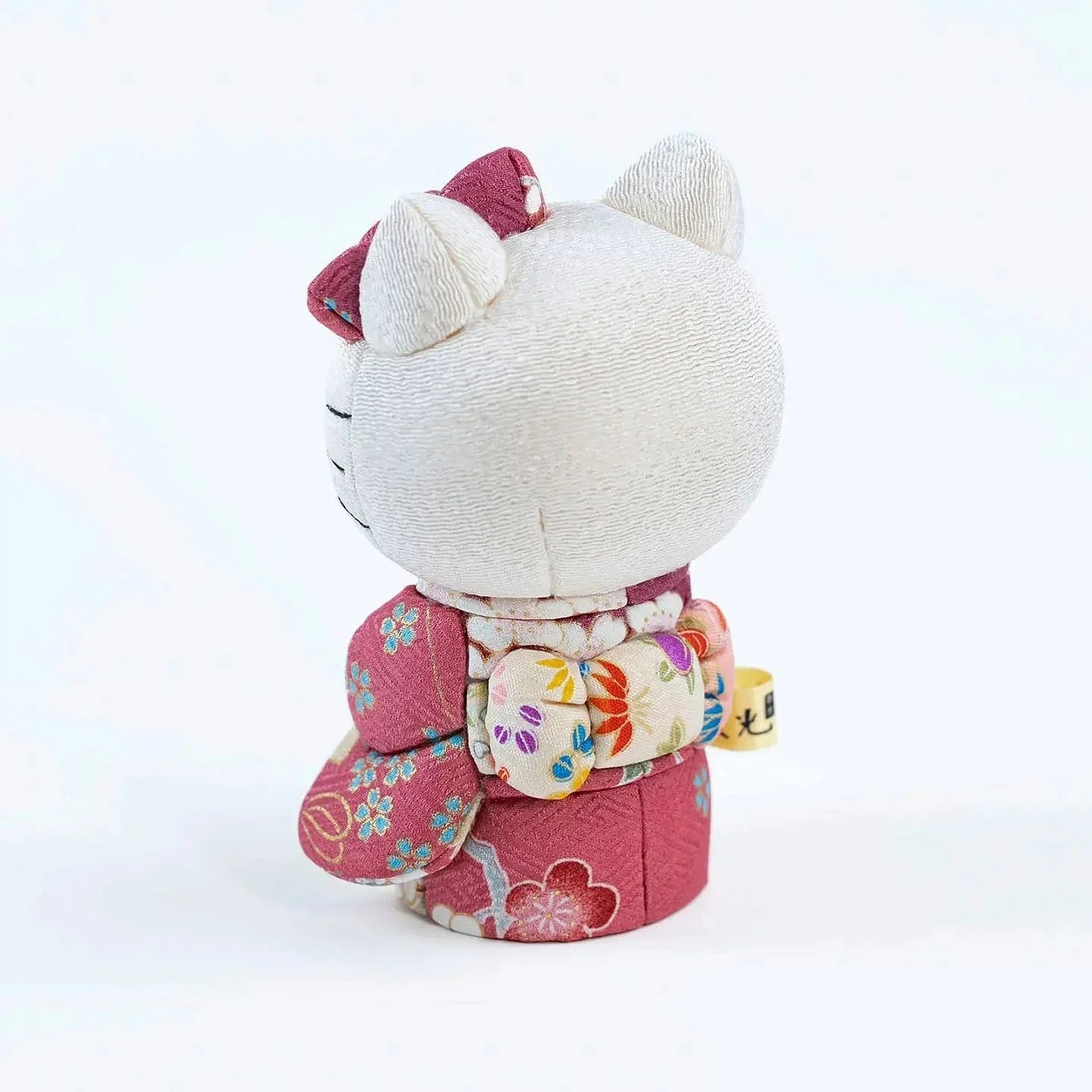 Back view of the Hello Kitty doll, showcasing the craftsmanship of the pink kimono's obi sash.