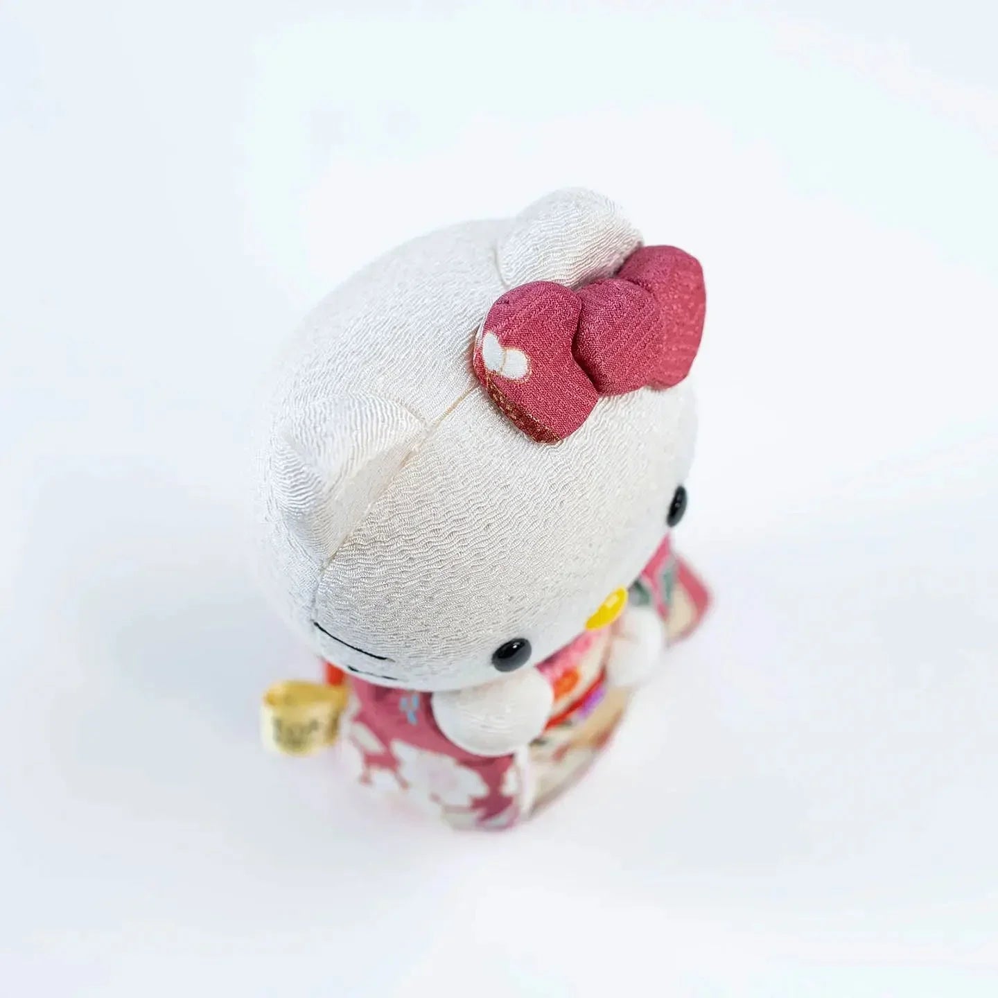 View of the Hello Kitty Maneki Neko doll on a white background.