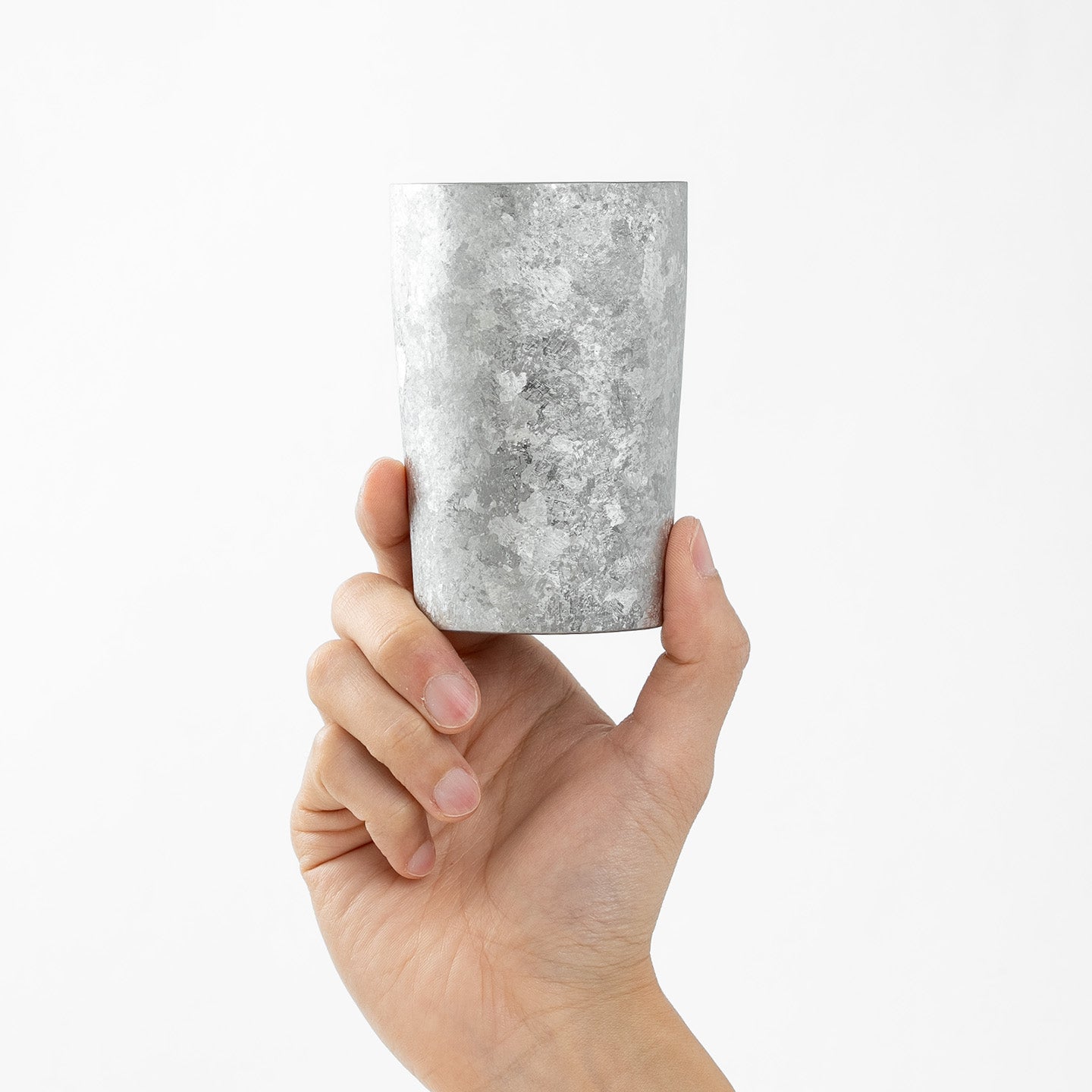 Hand holding HORIE Kamazukuri 270ml Silver Titanium Tumbler, side view, white background