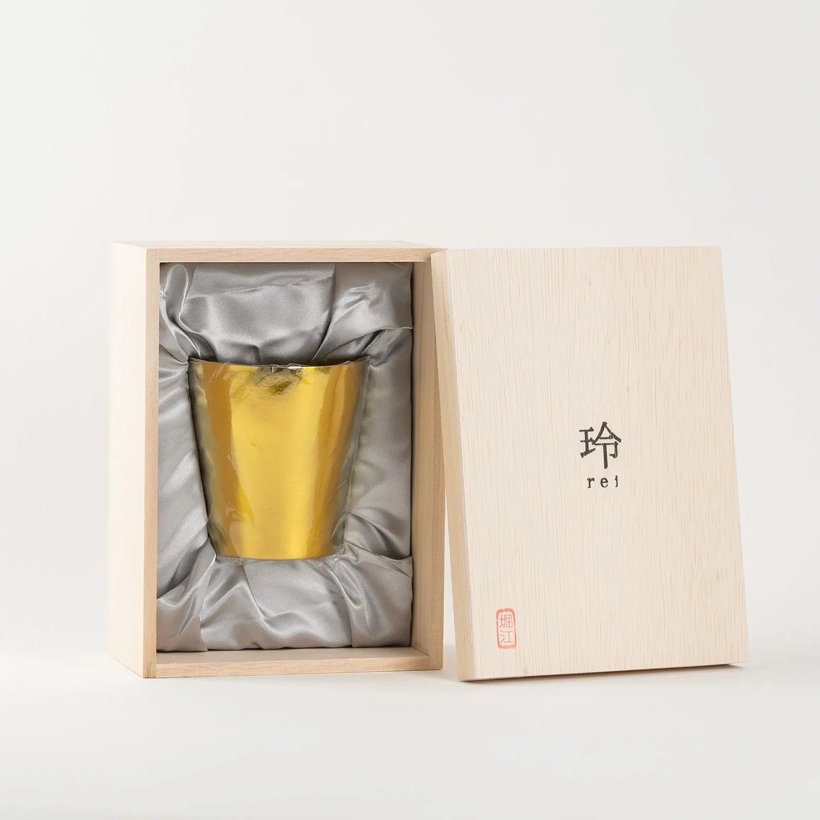 Bright gold HORIE tumbler placed inside gift box