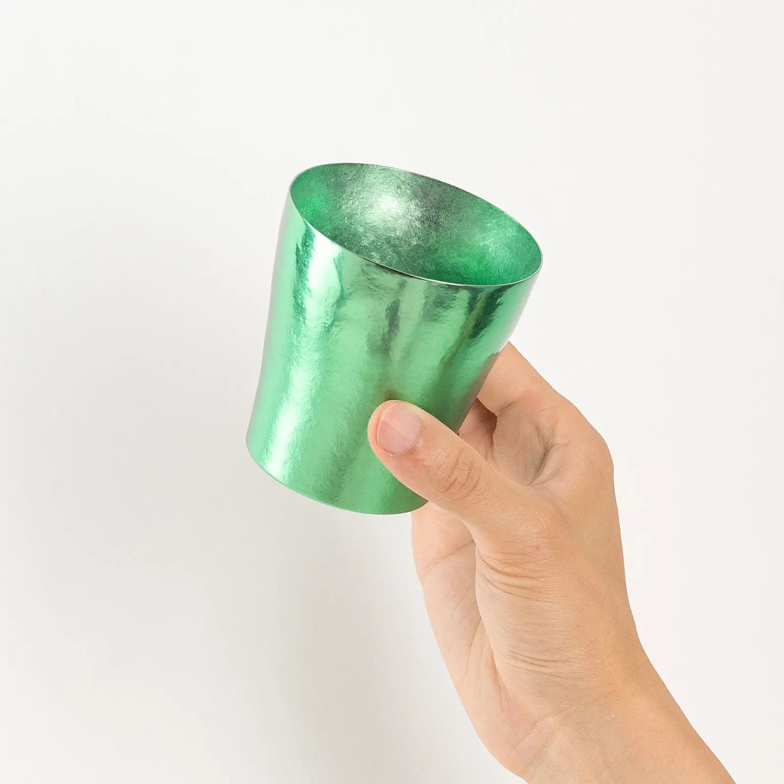 Top view of green titanium tumbler held in hand