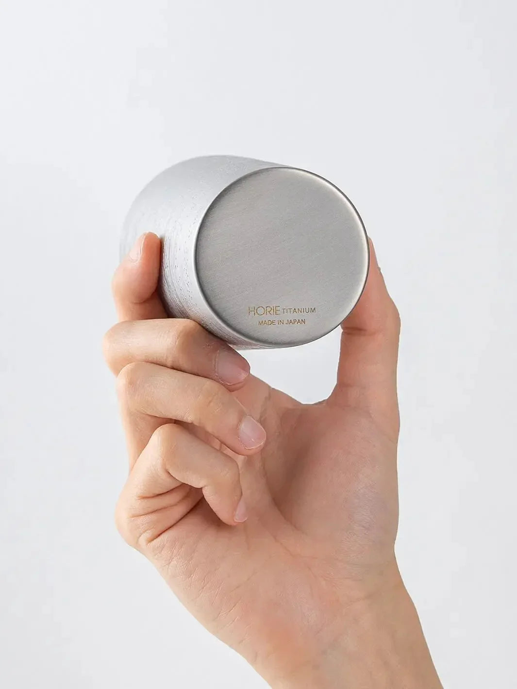 Bottom of HORIE Ryo Silver Mist tumbler (350ml) held in hand, showing engraved base