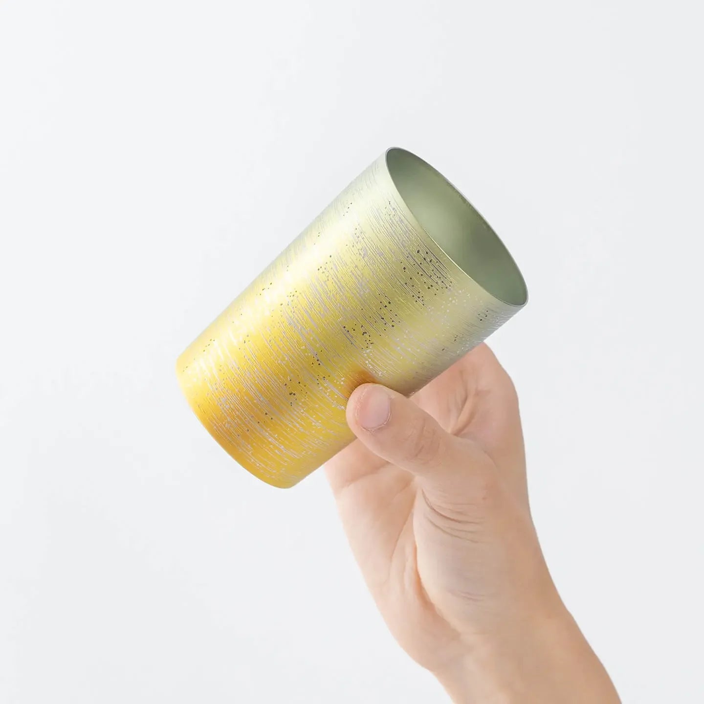 Double-walled titanium cup by HORIE – handcrafted Japanese gift in Sakura Green, in-hand view