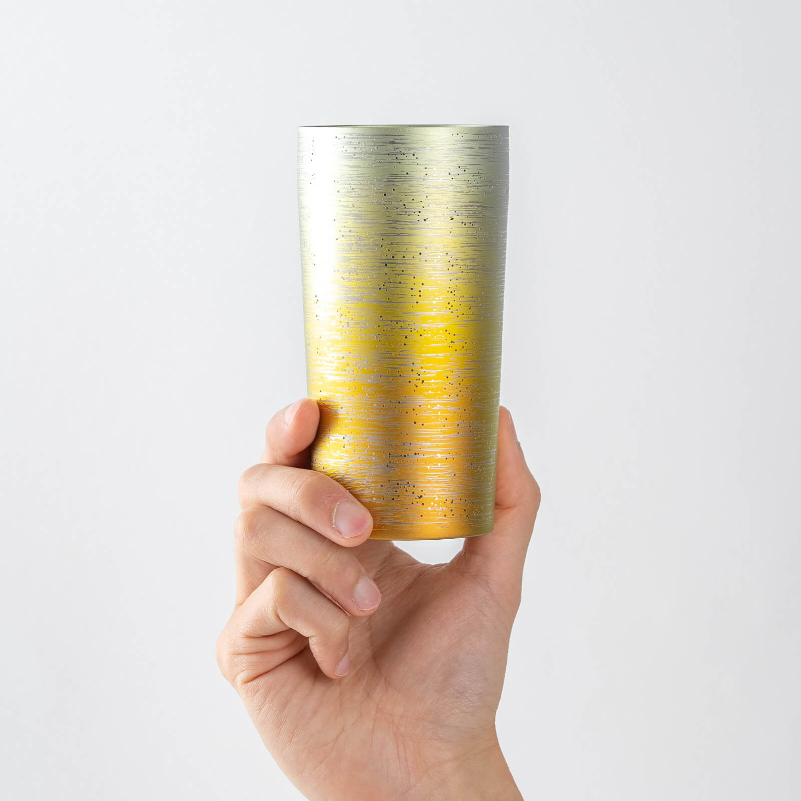 HORIE Ryo Sunset Gold titanium tumbler (350ml) held in hand, front view