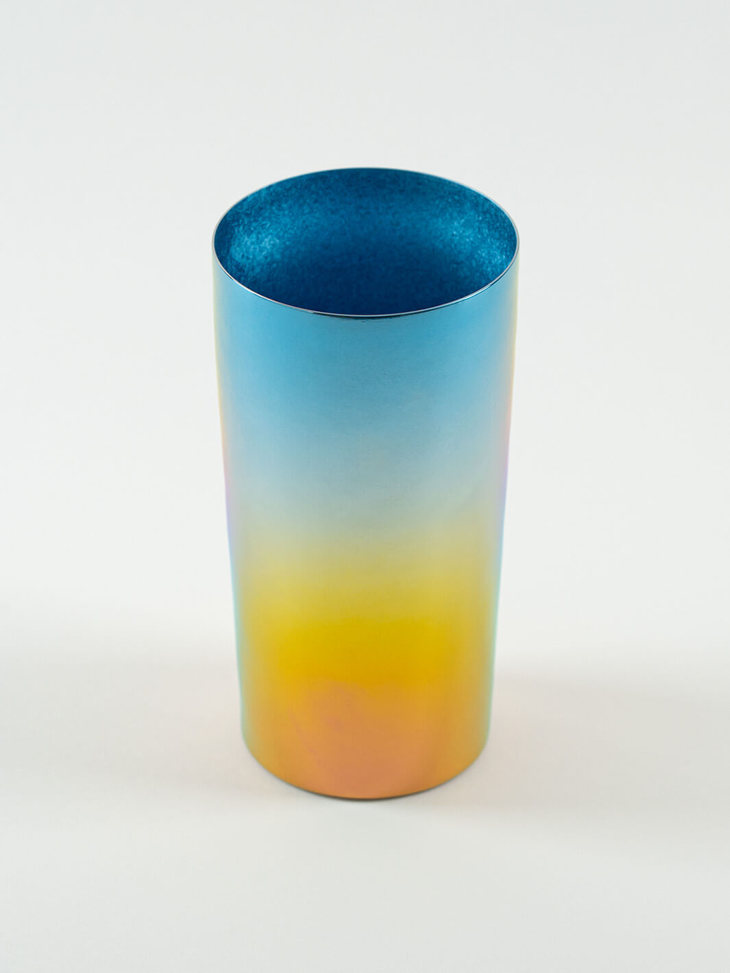 Top-angled view of HORIE Saiko rainbow titanium tumbler (350ml), showing vibrant gradient