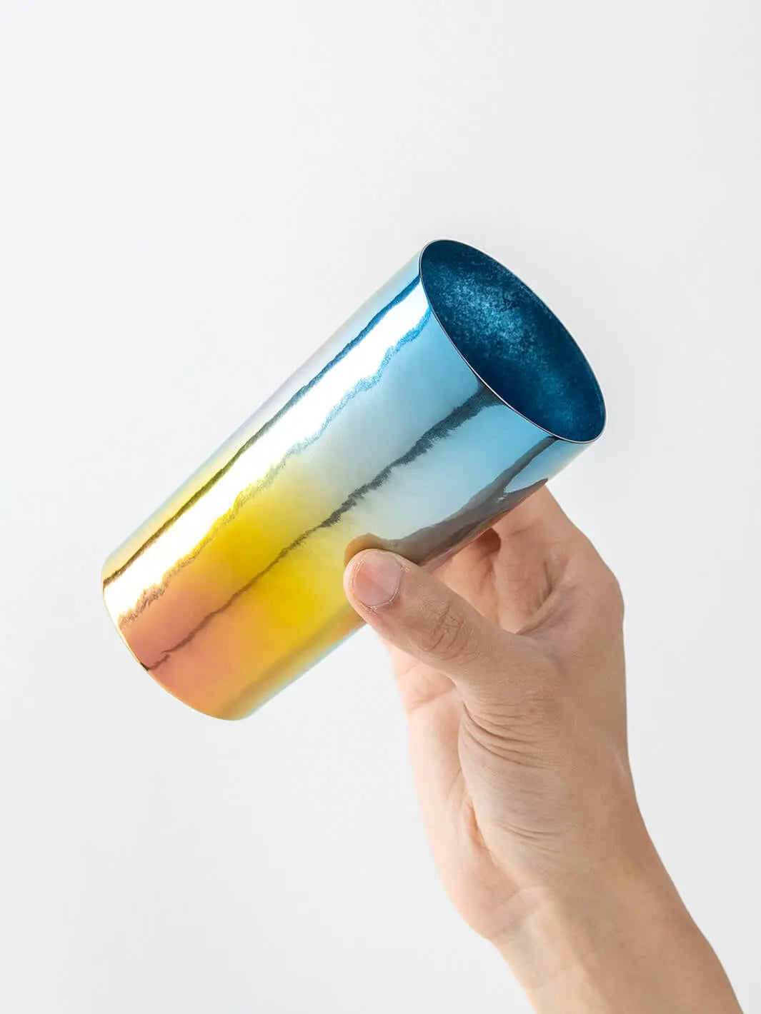 Side view of HORIE Saiko rainbow titanium tumbler (350ml) held in hand
