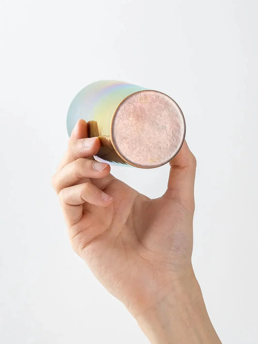 Bottom view of HORIE Saiko rainbow titanium tumbler (350ml) held in hand
