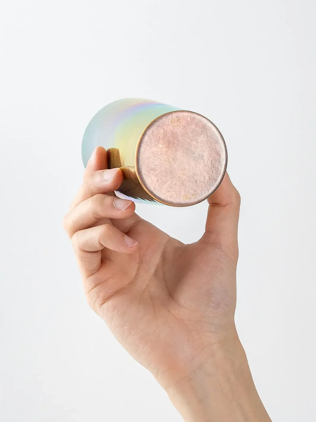 Bottom view of HORIE Saiko rainbow titanium tumbler (350ml) held in hand
