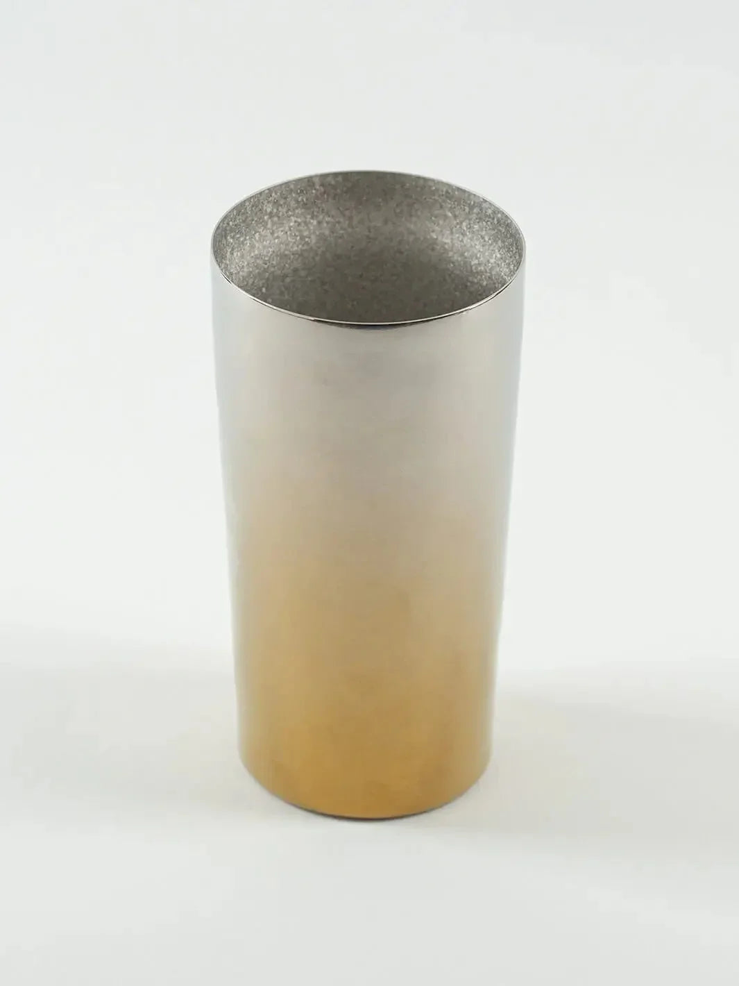 Top-angled view of HORIE Saiko gold-silver titanium tumbler (350ml), showing metallic sheen