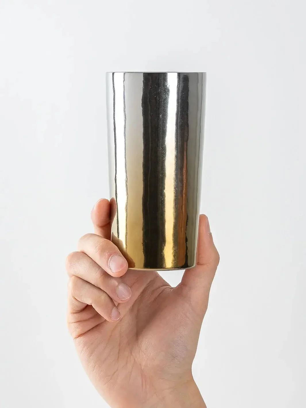 HORIE Saiko gold-silver titanium tumbler (350ml) held in hand, front view