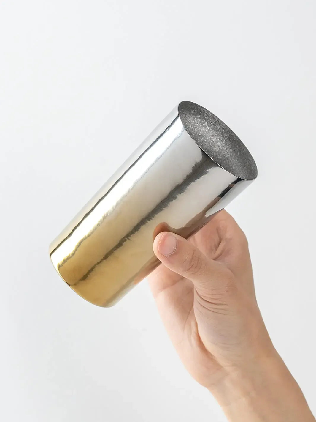 Side view of HORIE Saiko gold-silver titanium tumbler (350ml) held in hand