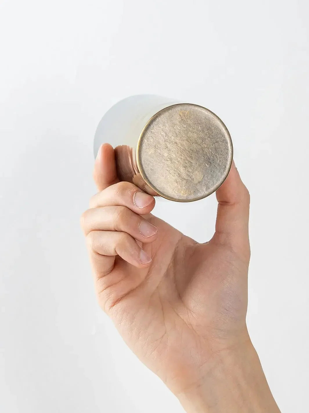 Bottom view of HORIE Saiko gold-silver titanium tumbler (350ml) held in hand