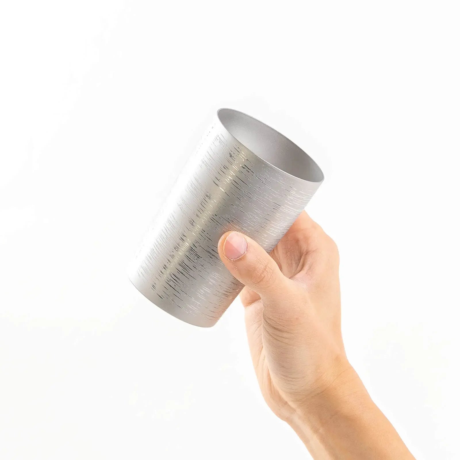 Insulated titanium tumbler 270ml silver, tilted in hand, HORIE Shirakaba Series