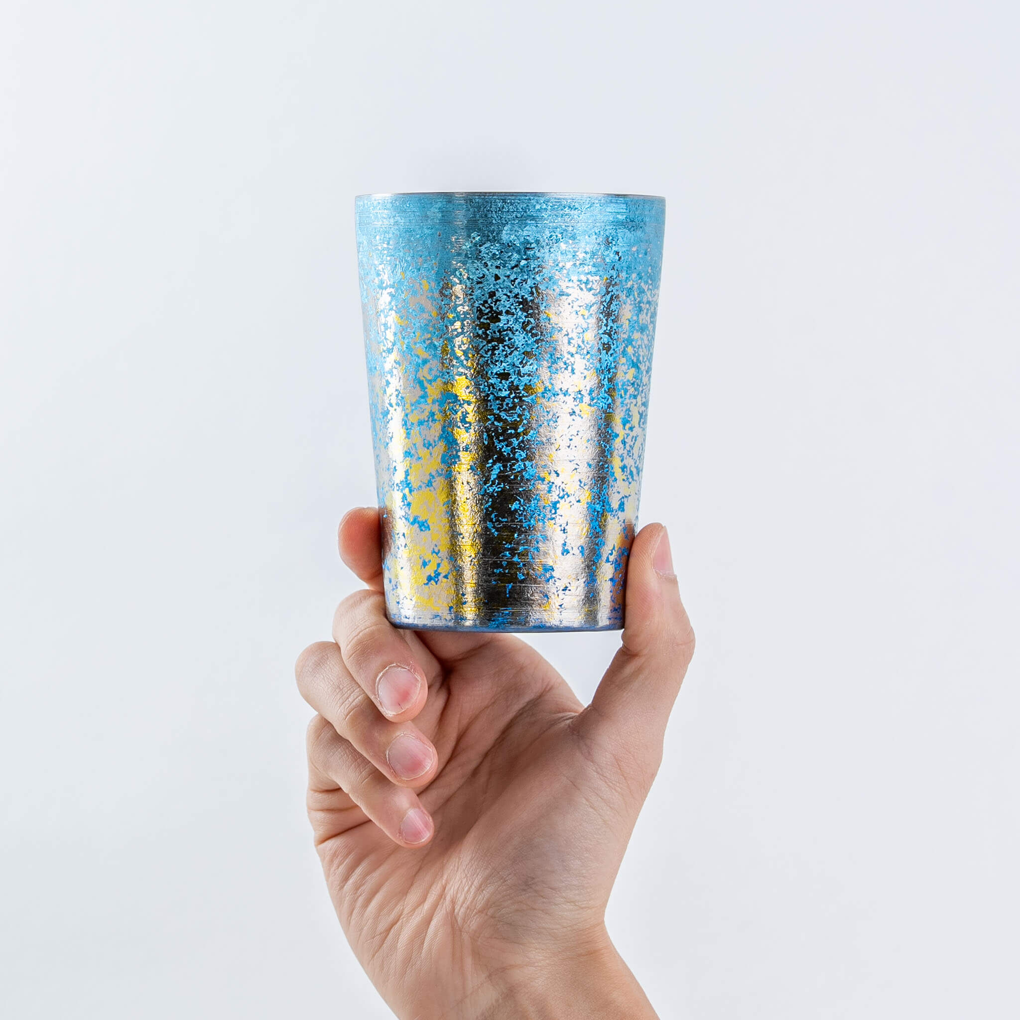 Hand holding a HORIE Taiko 400ml blue titanium tumbler