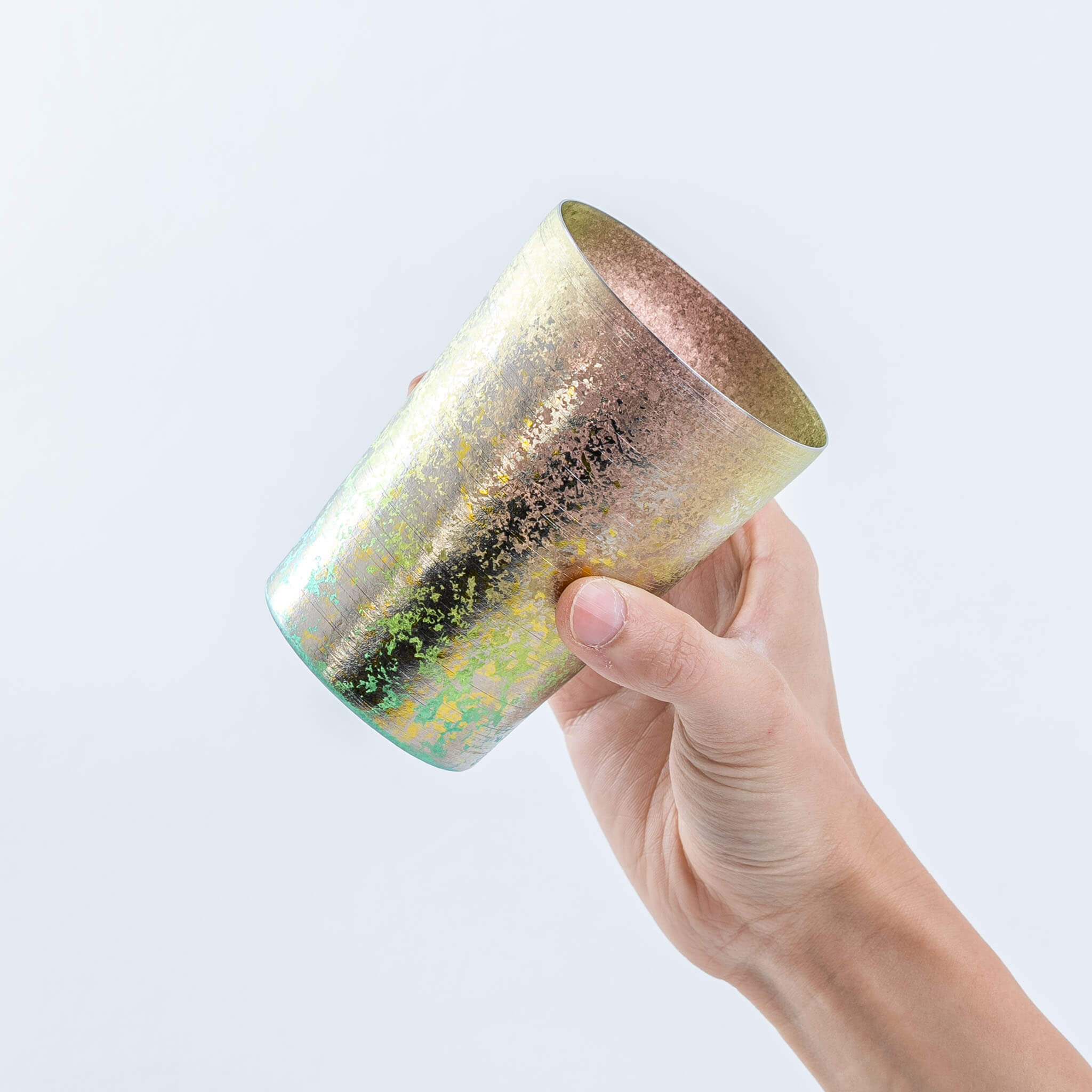 Side view of a hand holding the pink HORIE Taiko titanium tumbler