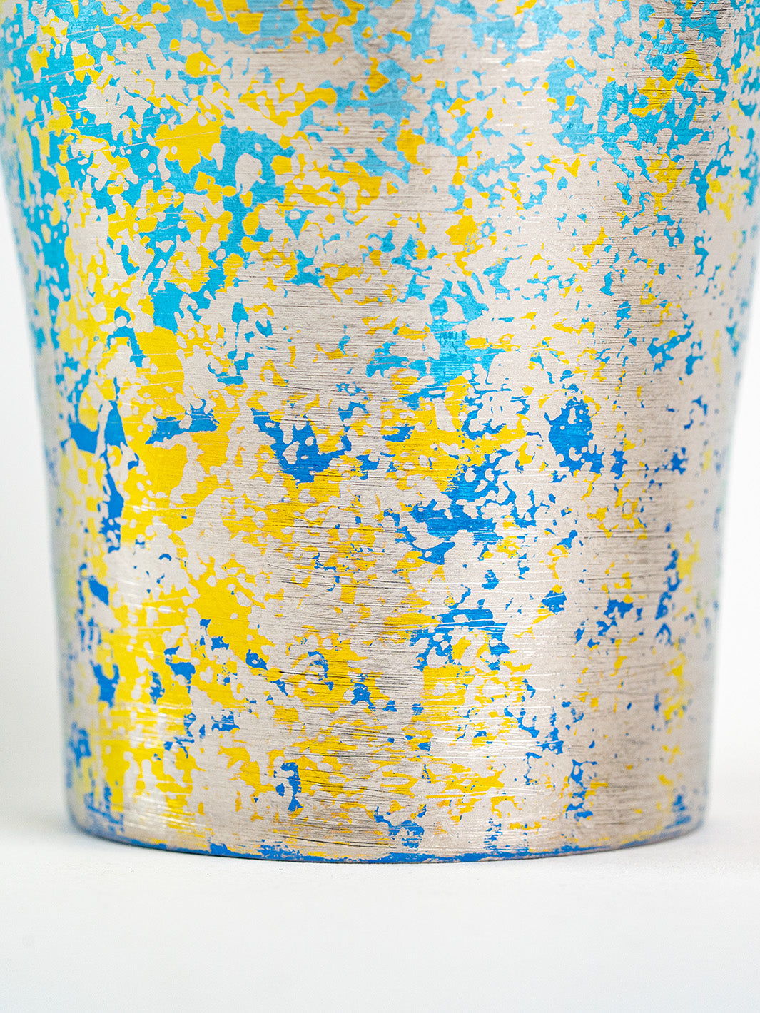 Close-up of lower surface texture on blue titanium tumbler