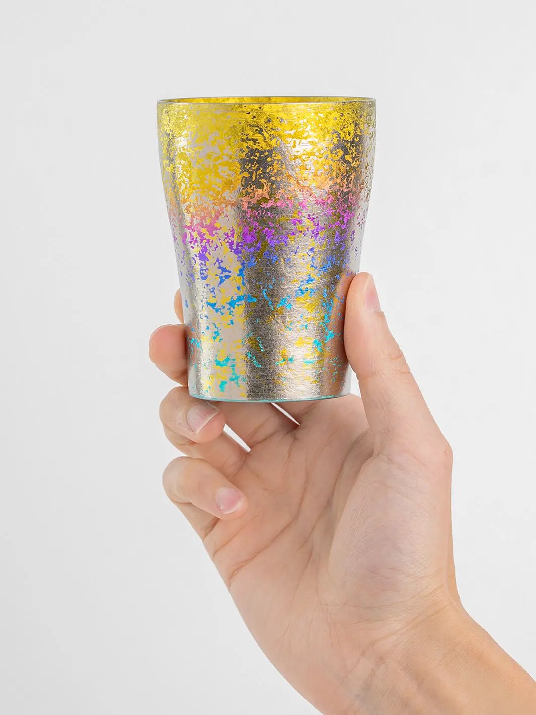 Rainbow titanium tumbler held from front, 250ml