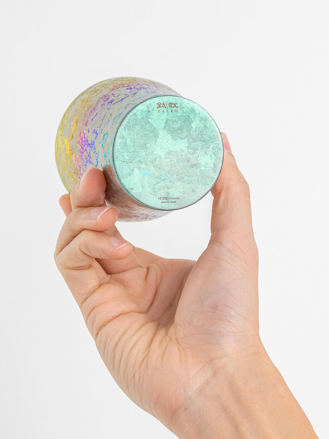 Bottom of rainbow HORIE tumbler shown in hand