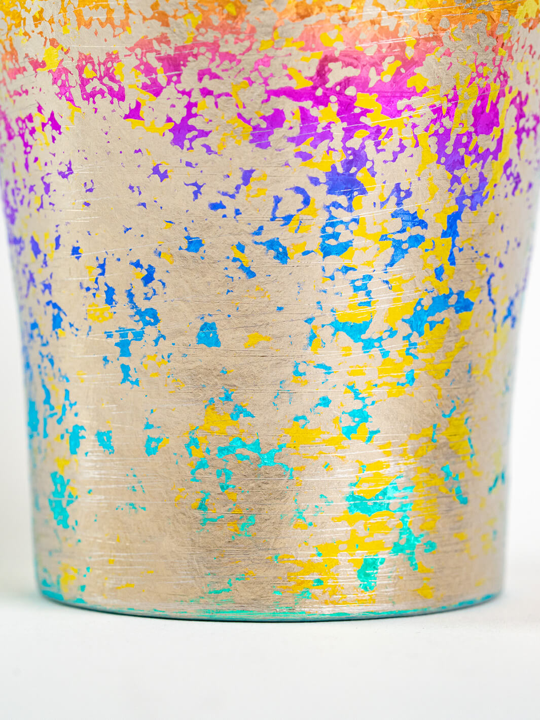 Close-up of lower surface texture on rainbow titanium tumbler