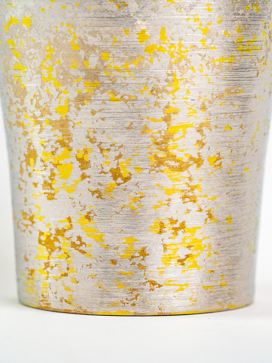 Surface texture detail on lower half of silver titanium tumbler