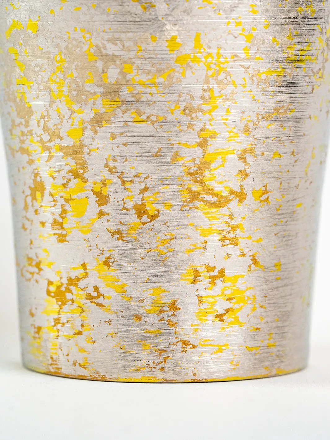 Surface texture detail on lower half of silver titanium tumbler