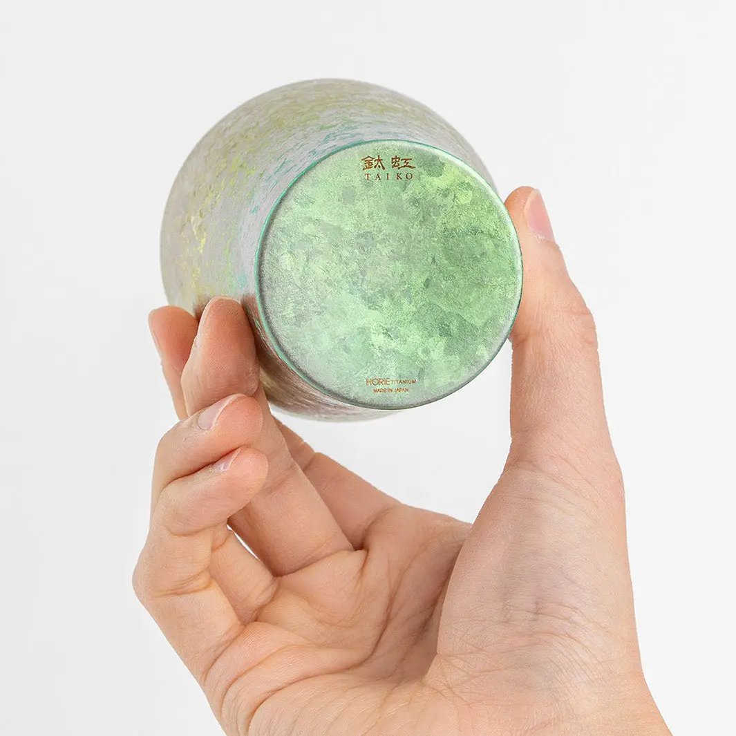 Bottom of pink titanium tumbler displayed in hand