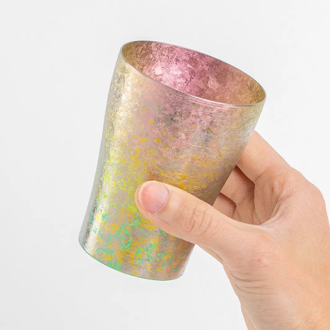 Side view of pink tumbler in hand
