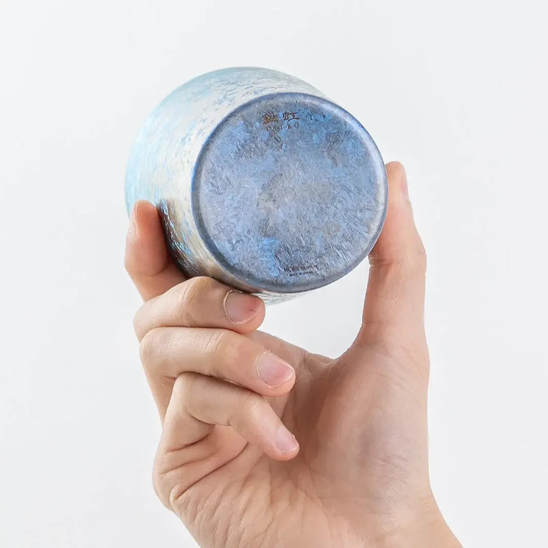 Bottom view of blue titanium tumbler in hand