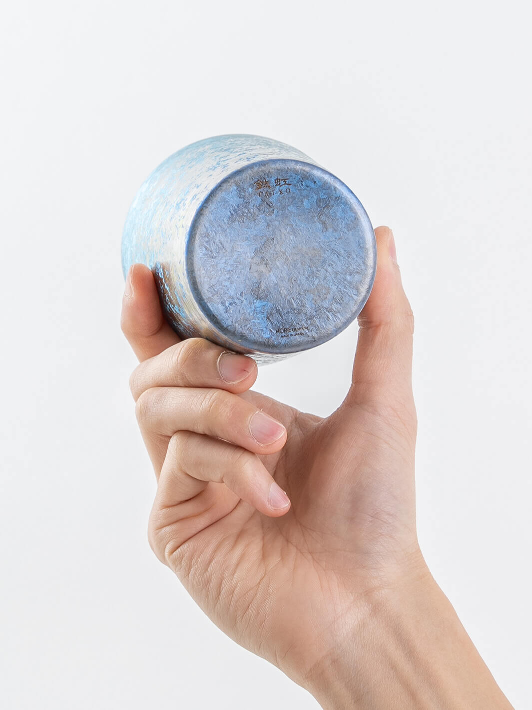 Bottom view of blue titanium tumbler in hand