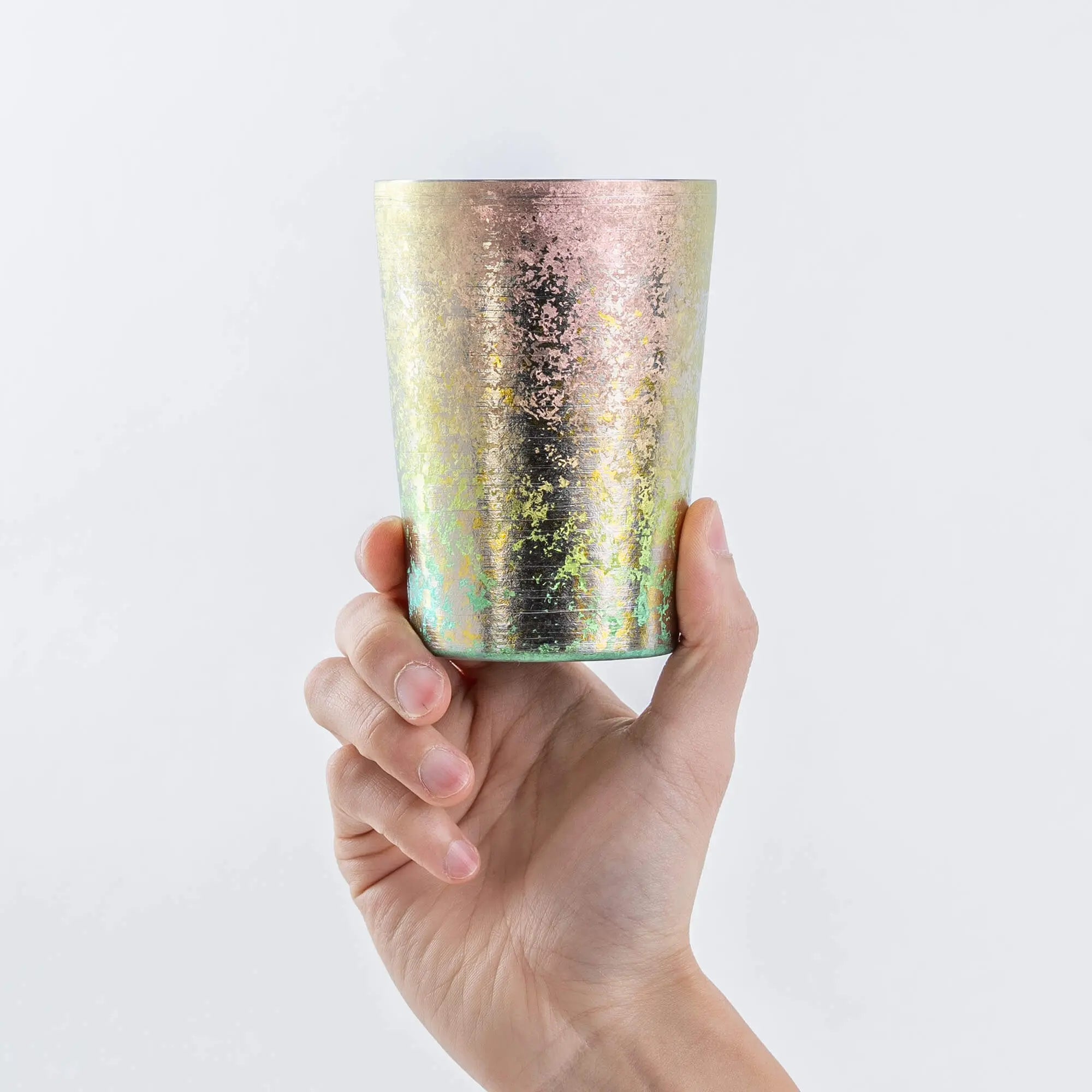 Pink titanium tumbler held upright in hand, 400ml