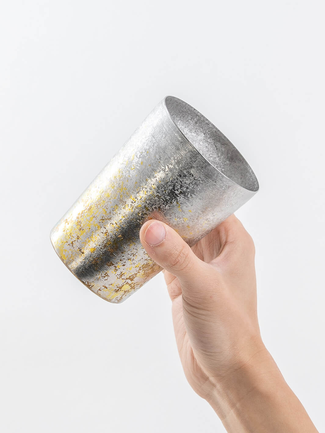 Side view of silver HORIE tumbler in hand