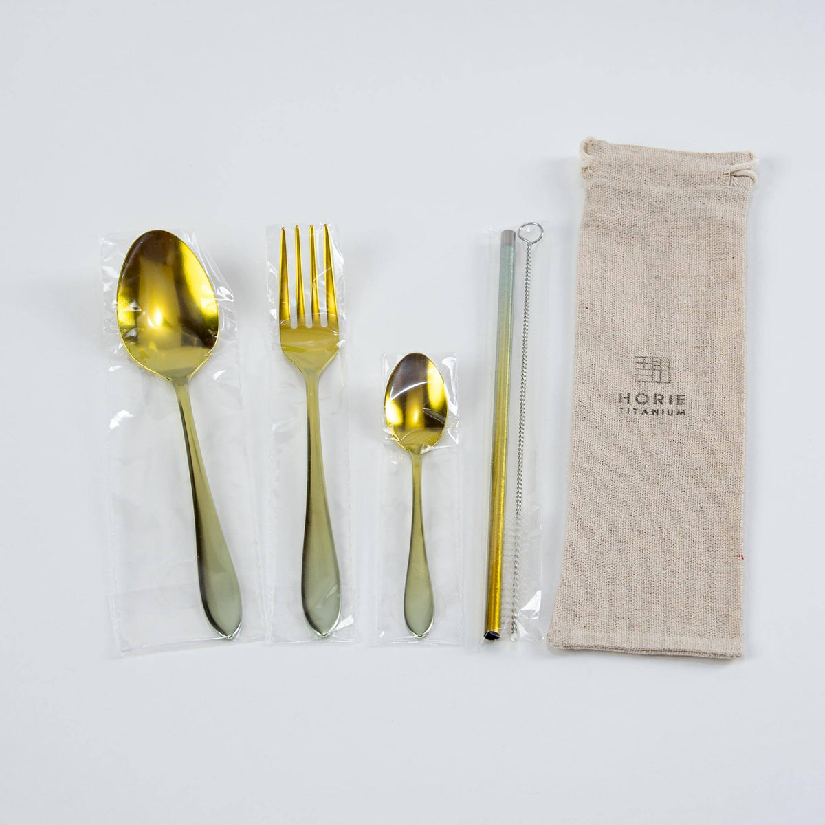 HORIE gold titanium cutlery set with spoon, fork, coffee spoon, straw, cleaning brush and linen pouch