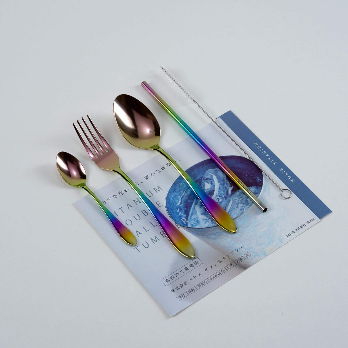 Rainbow HORIE pure titanium cutlery set arranged on a Japanese magazine