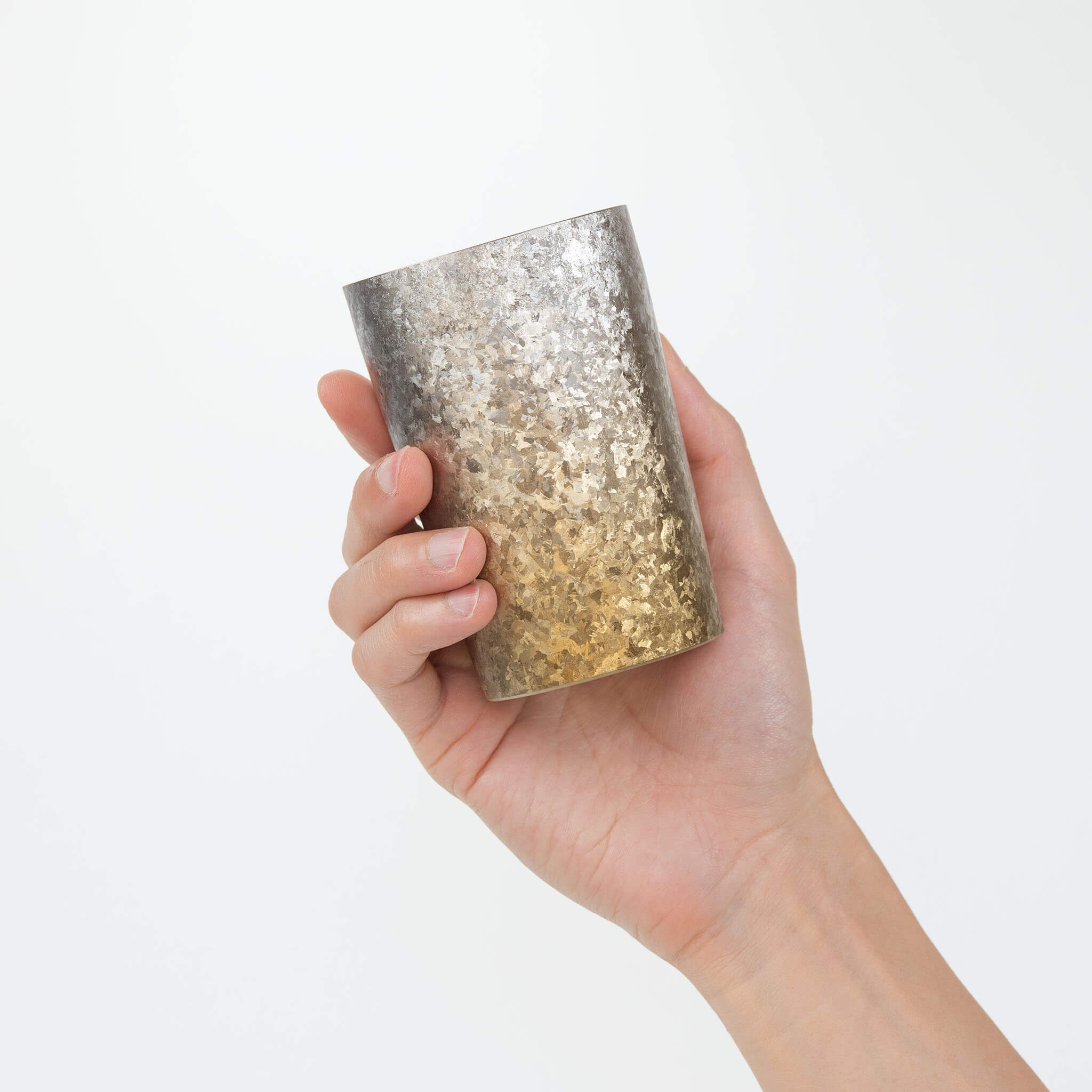 HORIE Titanium Kamazukuri 270ml Gold Silver Tumbler held in hand, side view showing gradient texture
