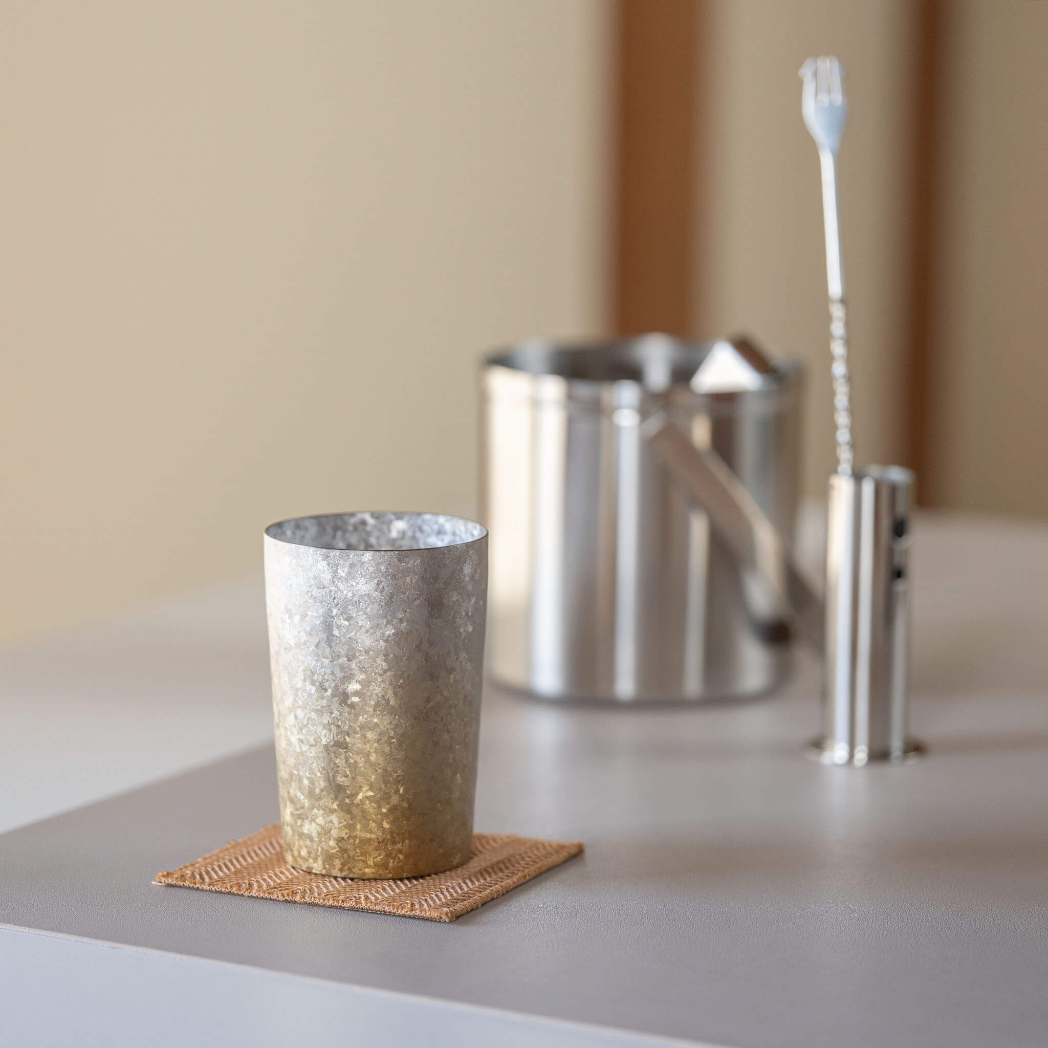 HORIE Titanium Kamazukuri 270ml Gold Silver Tumbler on coaster with ice bucket and bar spoon