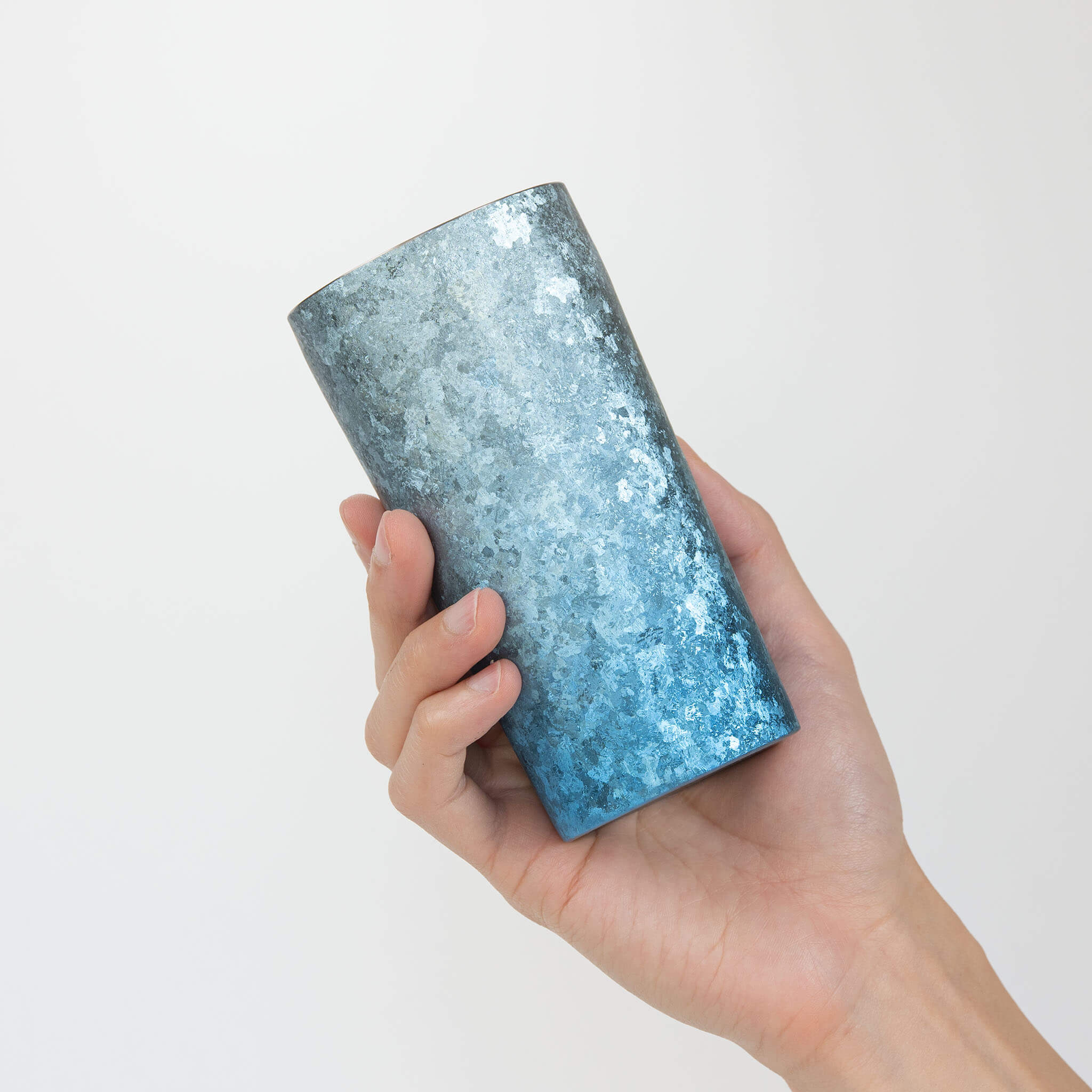 HORIE Titanium Kamazukuri 350ml Blue Tumbler tilted in hand showing interior and kiln-fired blue texture