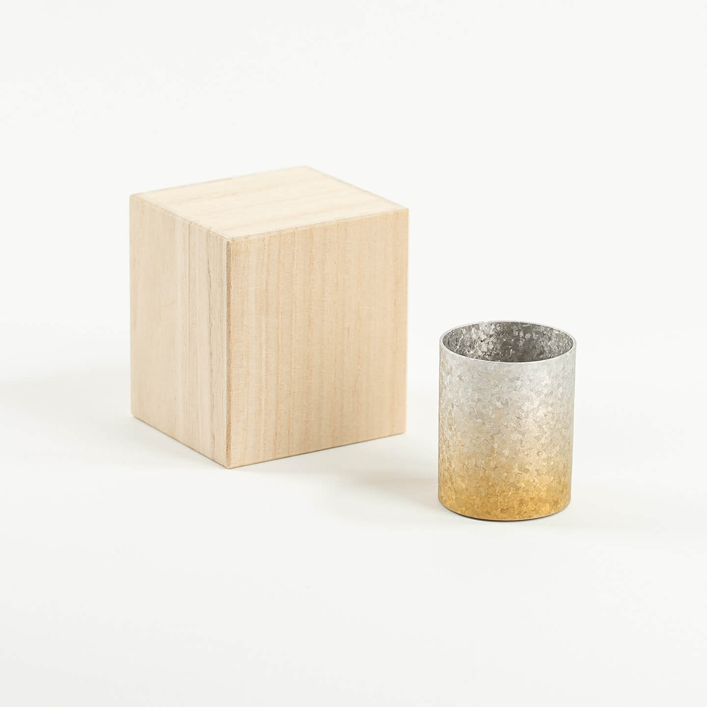 The HORIE Titanium Sake Cup (Gold & Silver Gradient) shown with its luxury paulownia wood gift box.