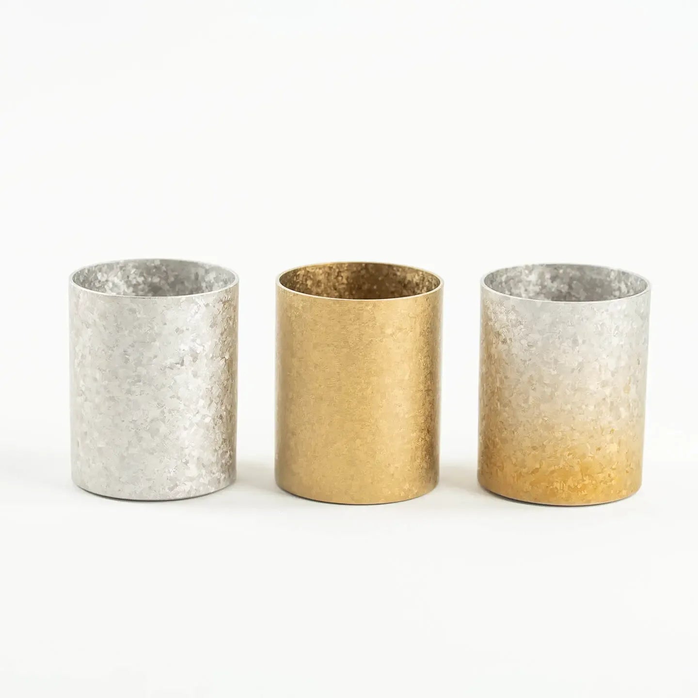 A side-by-side comparison of the HORIE Titanium Sake Cup in Silver, Gold, and Gold & Silver Gradient finishes.