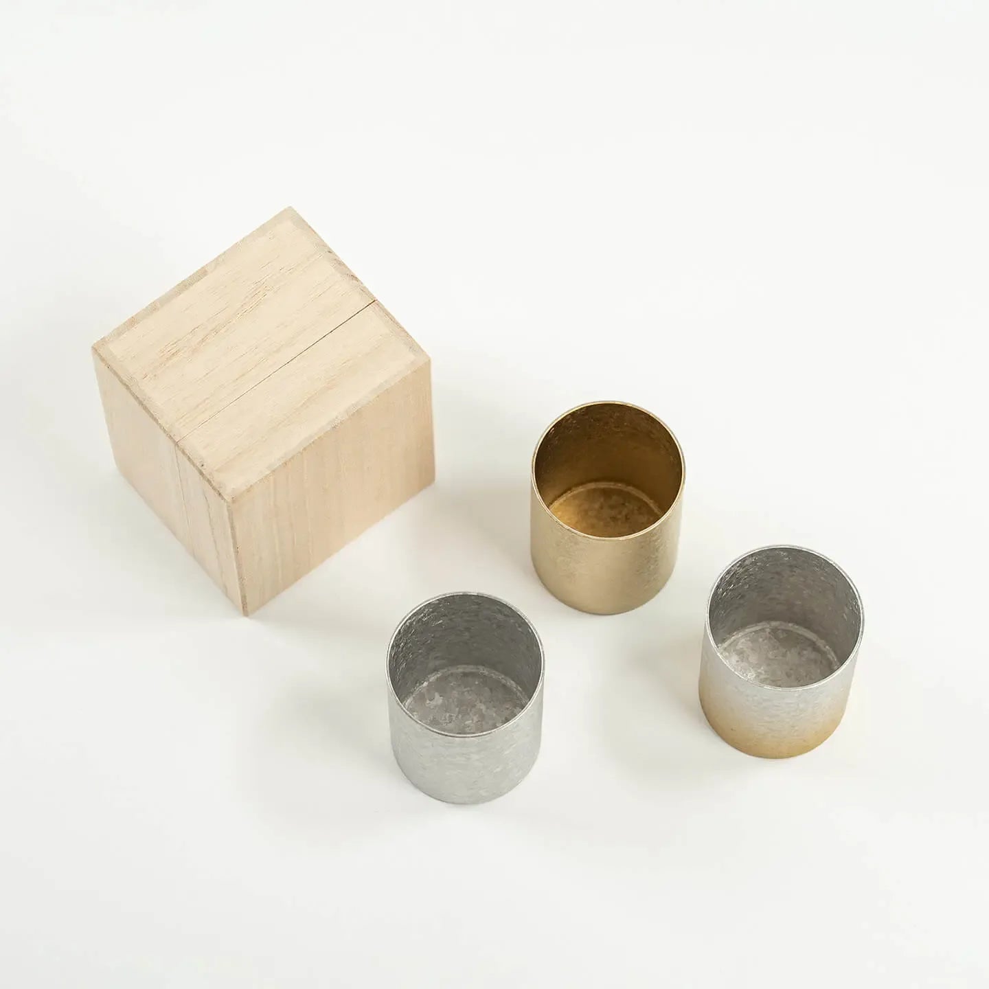 Top-down view showing the clean, pure titanium interiors of the HORIE Sake Cup trio.