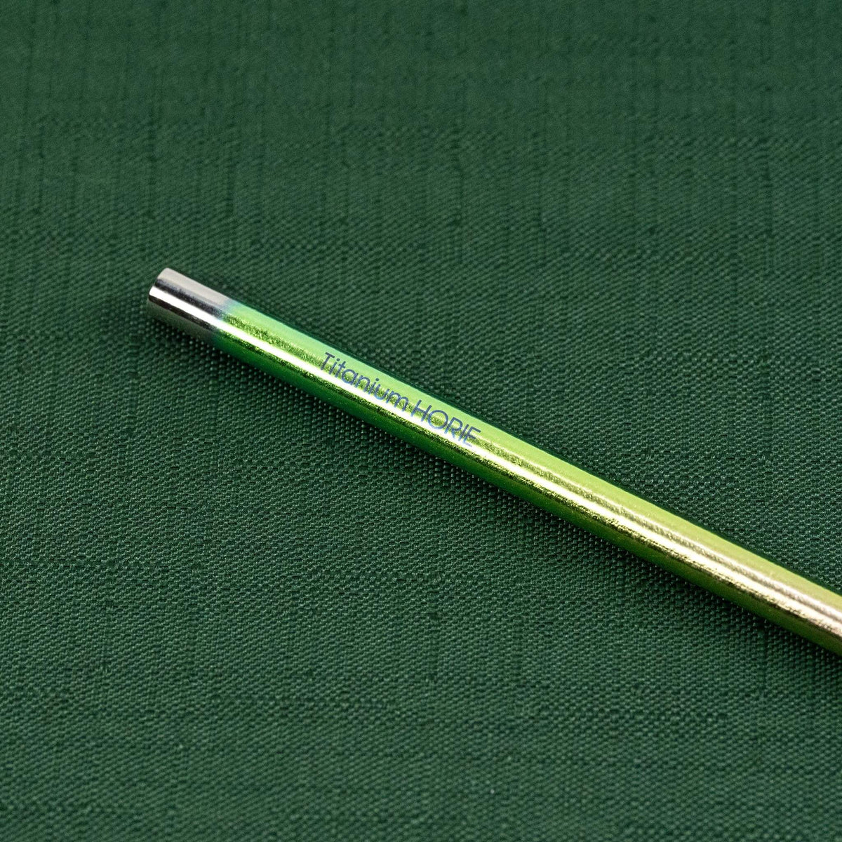 Close-up of the Titanium HORIE logo on the pink gradient titanium straw