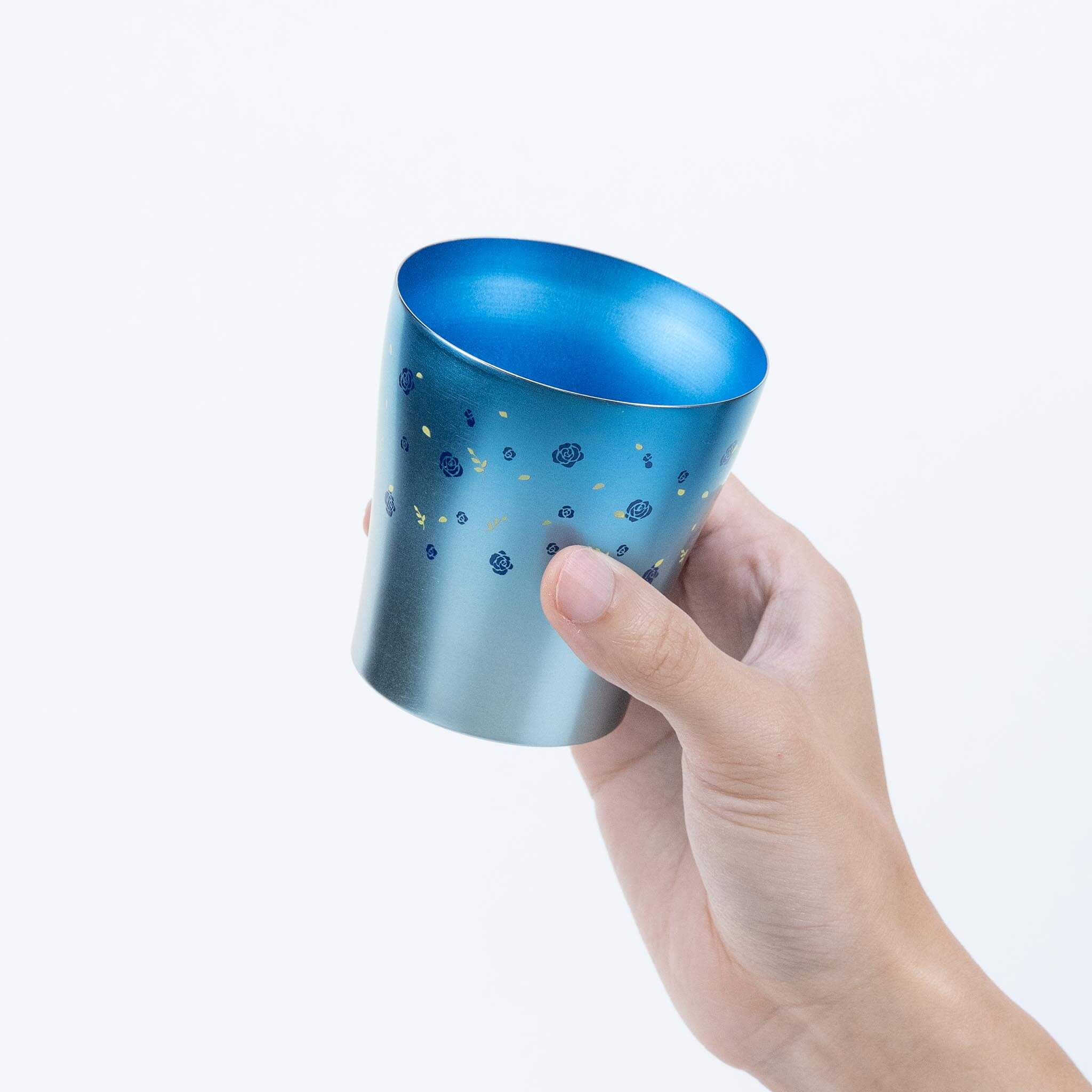 Side view of the blue HORIE Hana titanium tumbler held by hand