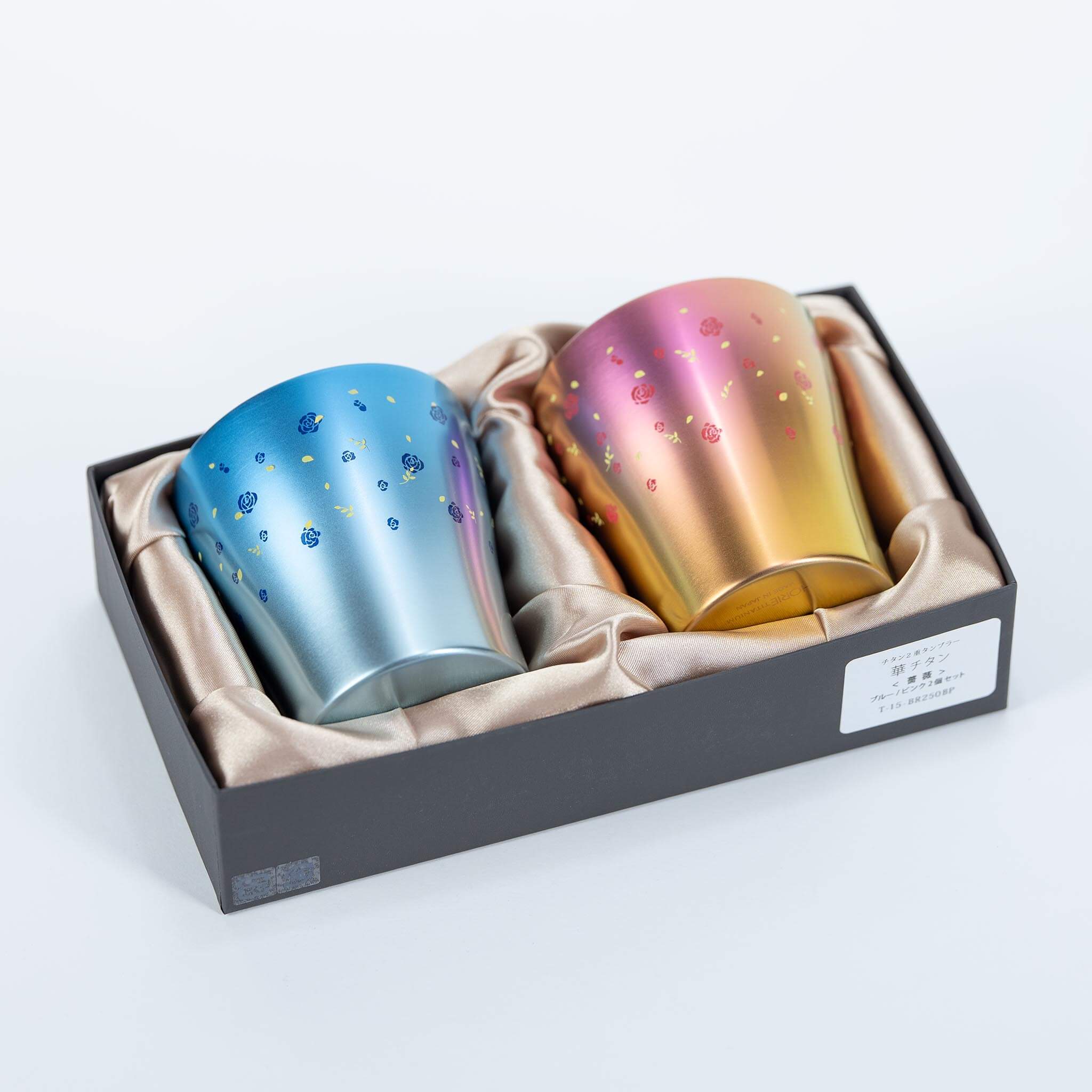 Angled view of the HORIE blue and pink titanium tumbler gift set