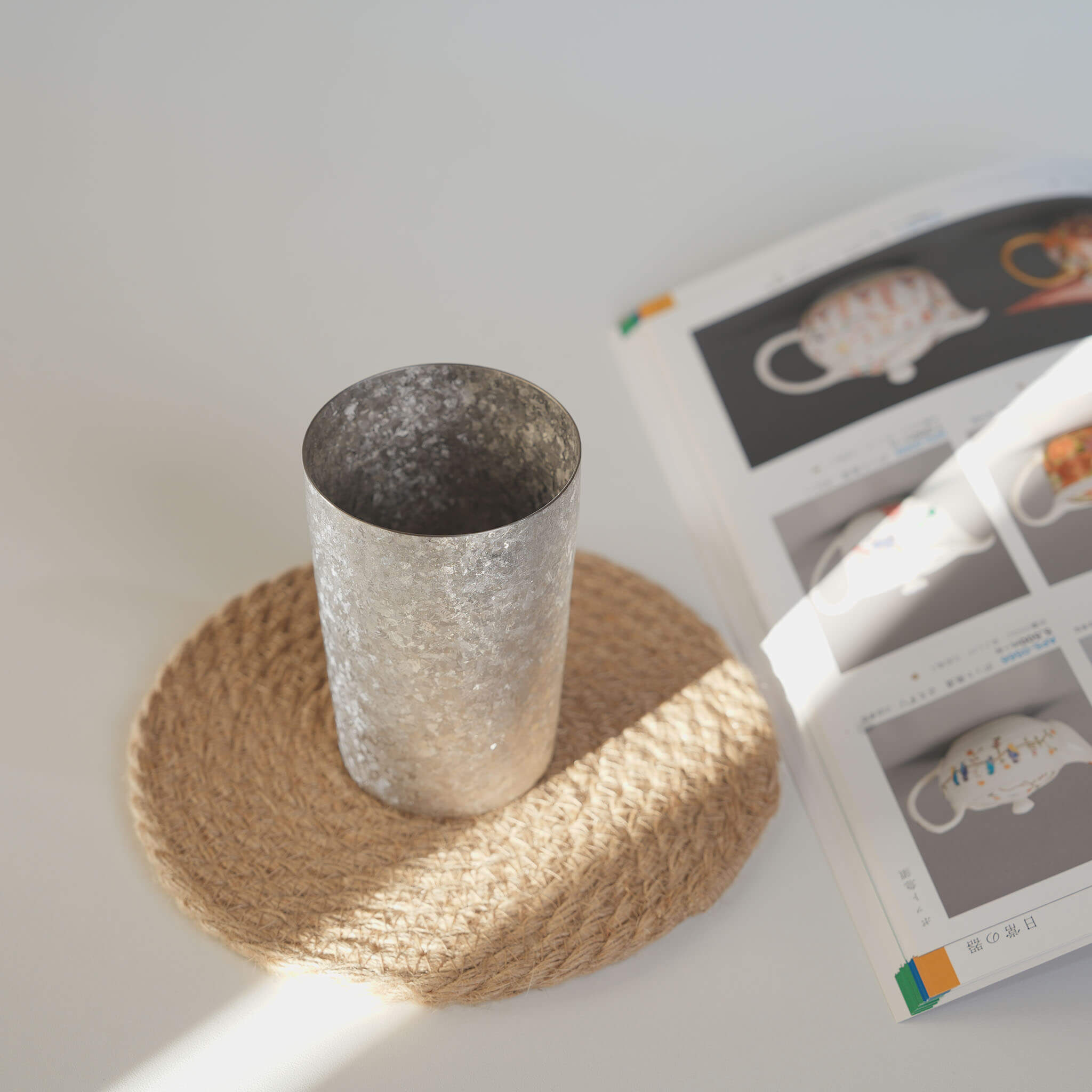 HORIE Kamazukuri 270ml Silver Titanium Tumbler on woven coaster, lifestyle shot