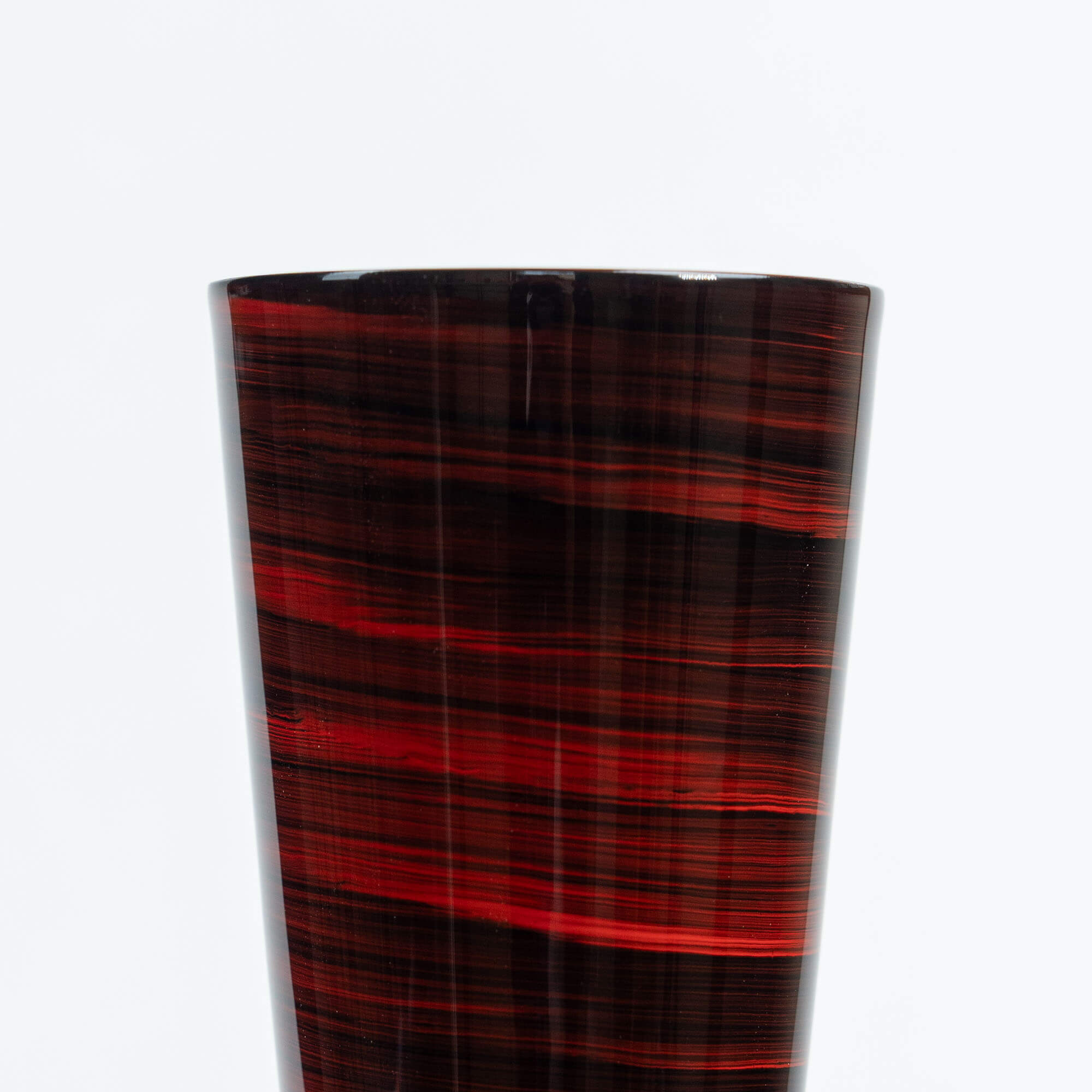 Close-up of the red striped lacquer finish on a Japanese stainless steel tumbler