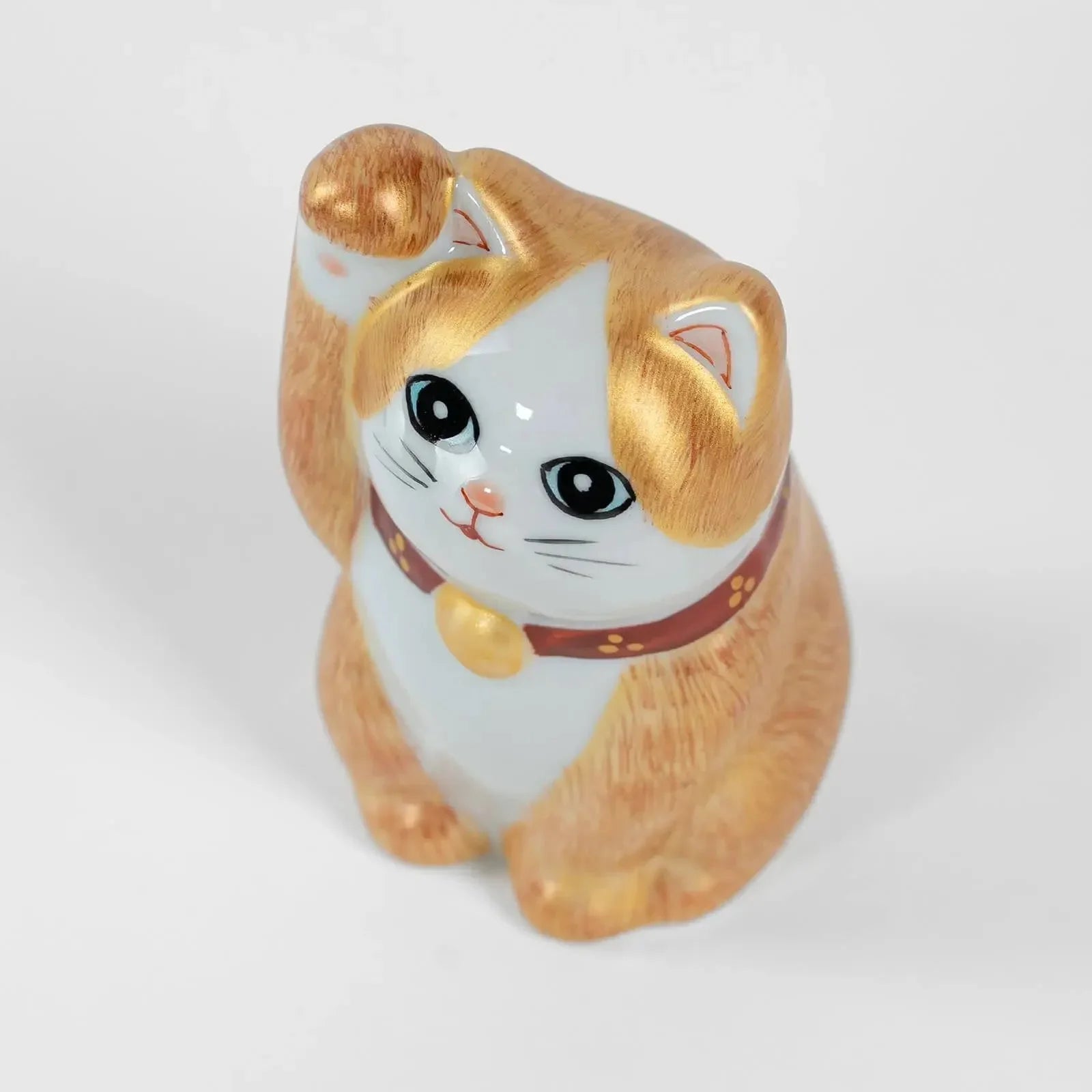 Top view of 10cm Kutani ceramic lucky cat, hand-painted details.