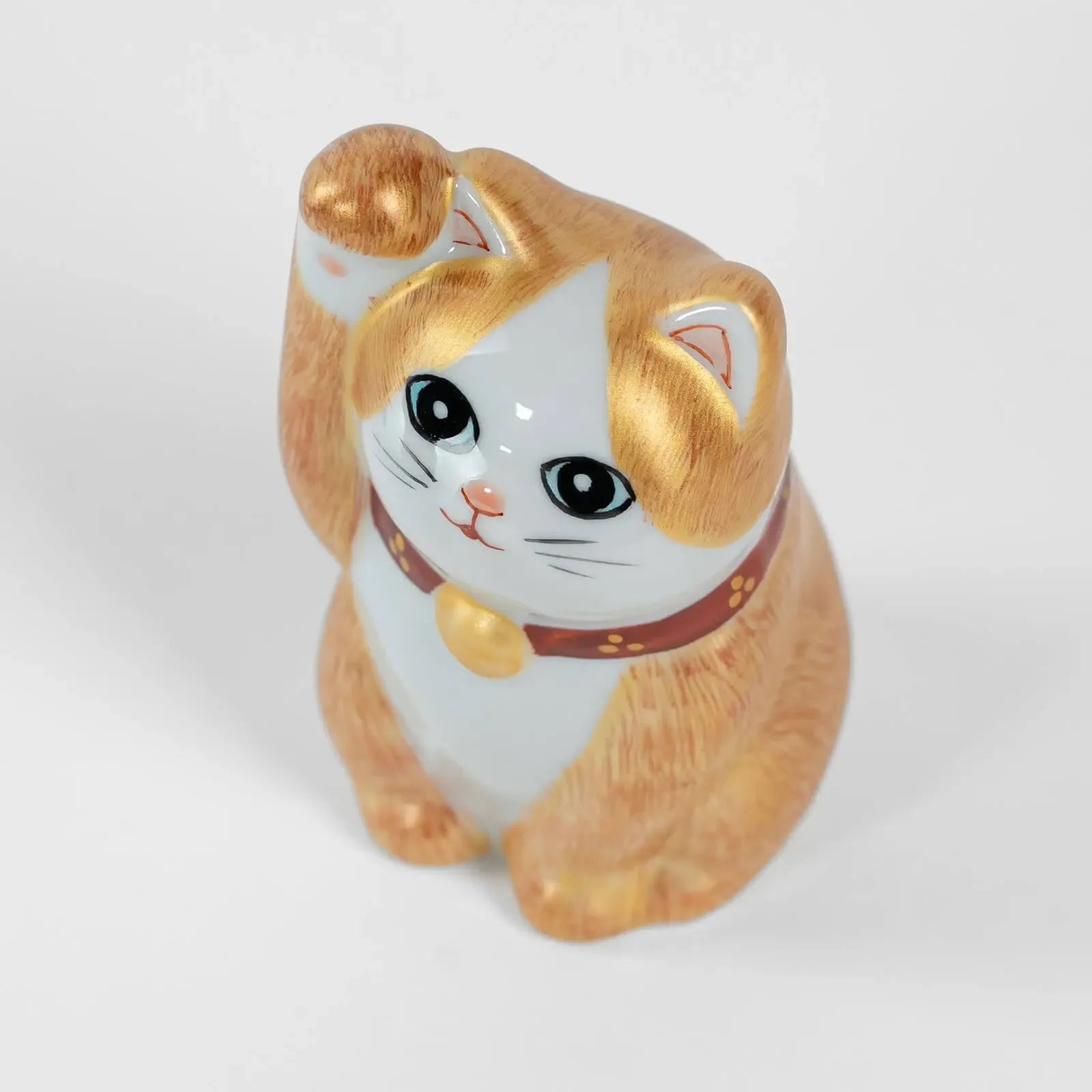 Top view of 10cm Kutani ceramic lucky cat, hand-painted details.